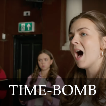 Photo of a brunette woman singing with the title Time-Bomb overlaid